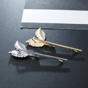 Minimalist leaf hair clips in gold and silver alloy finish with realistic leaf texture