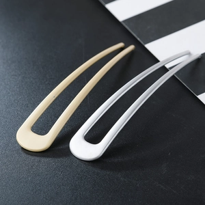Épingles à cheveux minimalistes en forme de U en beige et argent mat sur fond noir