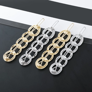 Set of four chain link hair clips in gold and silver finish with textured alloy details