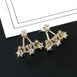 Detail of gold-tone ear jackets with sparkling crystal rhinestones in fan shape