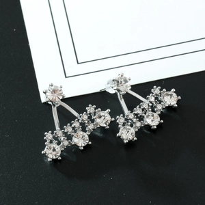 Macro shot of silver alloy triangle stud earrings featuring sparkling round rhinestones