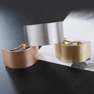 Detailed macro view of curved metal hair clips in silver, gold, and rose gold finishes