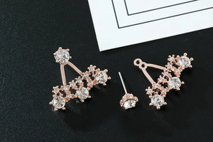 Detail view of rose gold alloy earrings with full rhinestone crown and fan patterns
