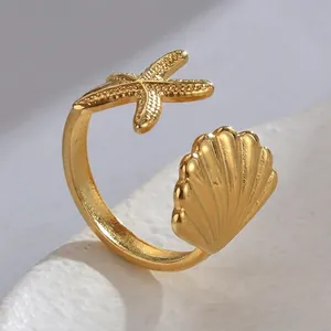 Elegant gold titanium steel open ring featuring detailed starfish and seashell motifs
