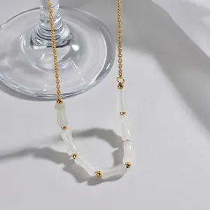 Dettaglio della collana a perle di bambù con pietre bianche e accenti dorati