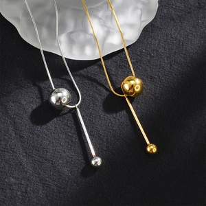 Minimalist geometric tassel necklace with round ball pendant in gold and silver finish