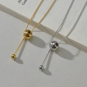 Minimalist gold and silver snake chain necklaces with sliding ball and bar pendants