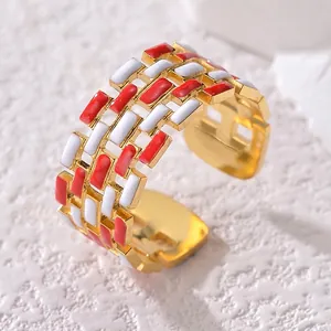 Fashionable hollow open ring with red and white enamel squares in gold plated finish