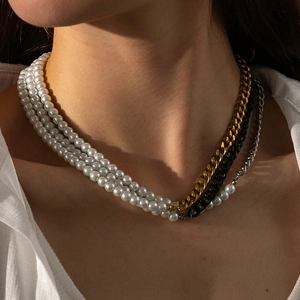 Detailed close-up of multilayer pearl and tri-color stainless steel chain necklace
