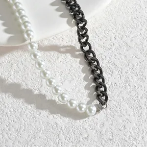 Detail of minimalist necklace with white pearls and chunky black stainless steel chain