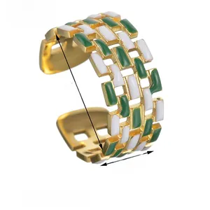 Detail view of gold titanium steel ring with green and white enamel brick pattern