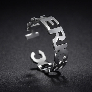 Macro shot of silver stainless steel ring with hollowed AMERICAN letters design