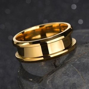 Detail macro view of 8mm golden grooved stainless steel ring on dark textured stone