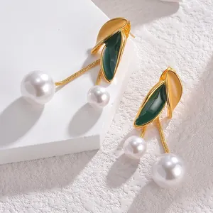 French vintage gold earrings with green leaf details and long hanging white pearls