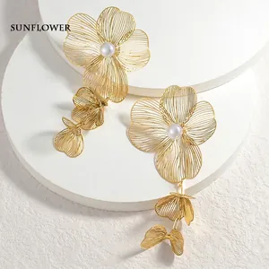 Elegant gold filigree flower tassel earrings with pearls and delicate wire texture