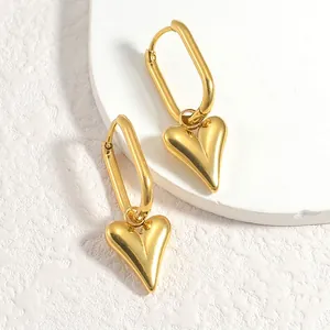 French vintage style geometric gold heart drop earrings on a white display stand