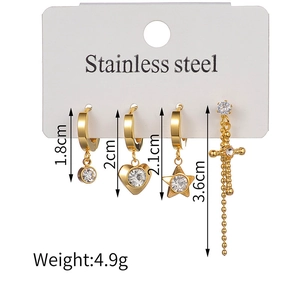 Detail view of 18K gold plated stainless steel earring set with cross and heart charms