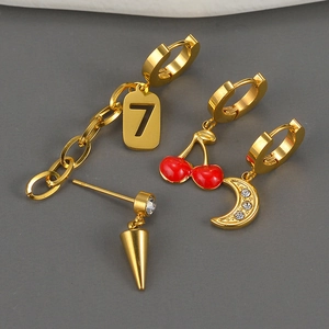 Detail of 18K gold-plated earrings set with cherry, moon, and geometric pendants