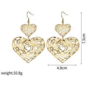 Detailed view of large gold hollow heart earrings with 7.5cm x 4.8cm size measurements