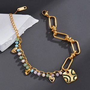 Detail of a geometric flower charm bracelet with pastel beads and gold chain links