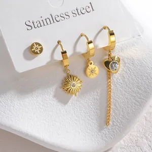 Detailed close-up of 4-piece gold-plated titanium steel earrings set on white display card