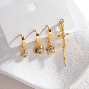 Detail of four-piece gold stainless steel earring set with zircon hearts and stars