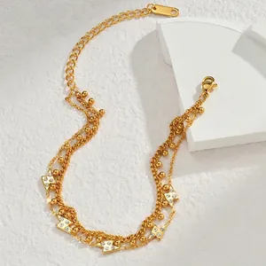 Detail of 18K gold-plated double-layer bracelet featuring sparkling zircon lightning charms