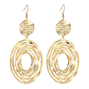 Close-up of geometric hollow earrings with textured sandblasted finish in 18K gold