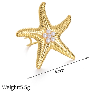 Detail view showing 4cm golden starfish ring with pearls and engraved texture