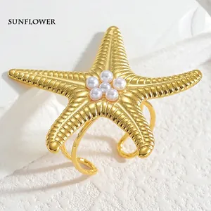 Exaggerated golden starfish open ring with pearl center and elegant titanium steel band