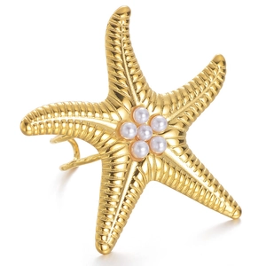 Detailed macro view of golden starfish ring with pearls and fine textured tentacles