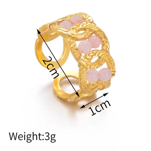 Detailed view of gold woven metal ring with pink crystal beads and size measurements