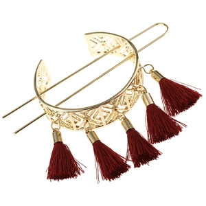 Detail of vintage geometric flower hollow hairpin with red silk tassels in gold finish