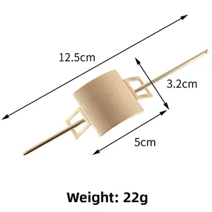 Macro detail of matte gold brushed alloy hair pin with 12.5cm stick and 5cm geometric plate