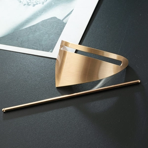 Detailed macro view of gold-finished brushed metal geometric hair pin and hollow plate