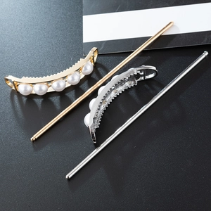 Set di forcine per capelli oro e argento con perle ovali su sfondo nero elegante