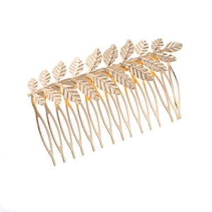 Close-up of golden metal leaf hair comb showing intricate natural leaf textures and gold finish