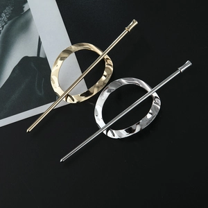 Polished gold and silver irregular hollow metal hair pins on a matte black background