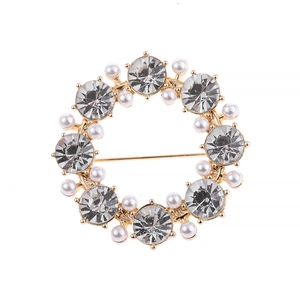 Elegant gold round floral brooch with sparkling rhinestones and white pearls for parties