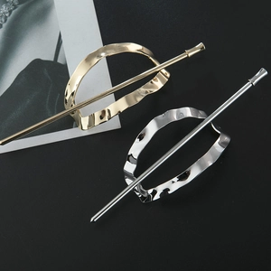 Detail view of gold and silver hollow oval hairpins with wavy textured finish