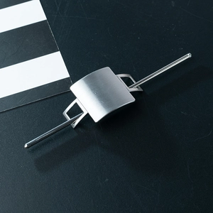 Minimalist silver alloy hair stick set with brushed metal finish on a black background