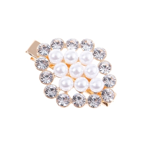 Detail of gold hair clip with nine white pearls and sparkling rhinestone halo