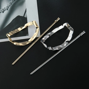 Detailed view of minimalist gold and silver oval hairpins with irregular wavy texture