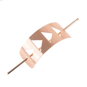 Macro detail of brushed rose gold metal hair slide with geometric hollow triangle design