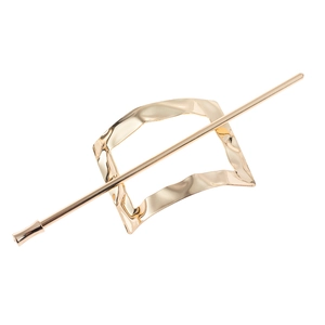 Detailed close-up of golden irregular metallic hair pin set with mirror polished finish