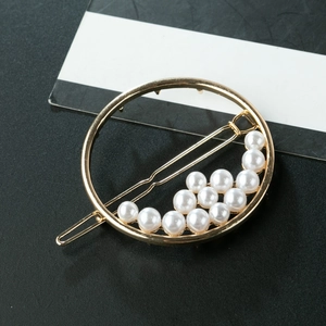 Elegant gold hollow circular hair clip with white pearls arranged along the inner rim
