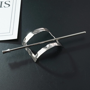 Detailed macro view of the silver wavy textured hair slide and minimalist matching stick