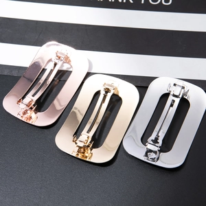 Three minimalist rectangle hair clips in rose gold, gold, and silver finishes