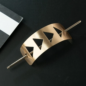 Detailed view of matte gold brushed finish metal hair pin with hollow triangle design