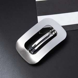 Detail view of rectangular silver metal hair clip with matte brushed finish and sleek design
